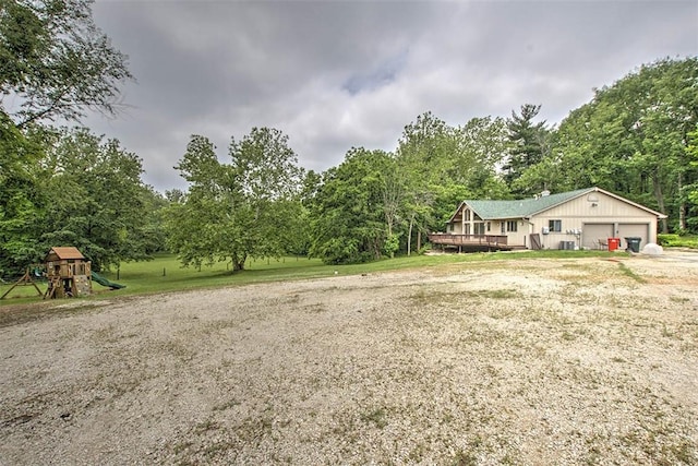 5959 Heritage Ln, Oakley, IL 62501 - view of yard with a garage, a playground, and a wooden deck
