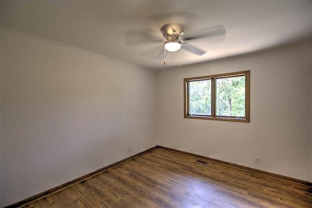 5959 Heritage Ln, Oakley, IL 62501 - empty room with baseboards, wood finished floors, ornamental molding, and ceiling fan