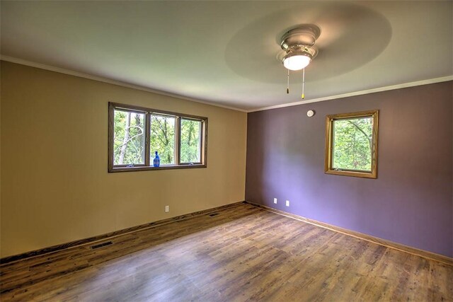 5959 Heritage Ln, Oakley, IL 62501 - empty room featuring ornamental molding, ceiling fan, wood finished floors, and baseboards