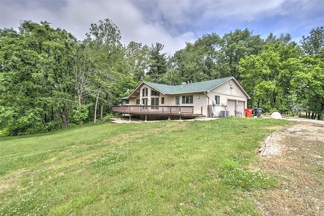 5959 Heritage Ln, Oakley, IL 62501 - view of front of home with an attached garage, a front yard, a wooden deck, and cooling unit