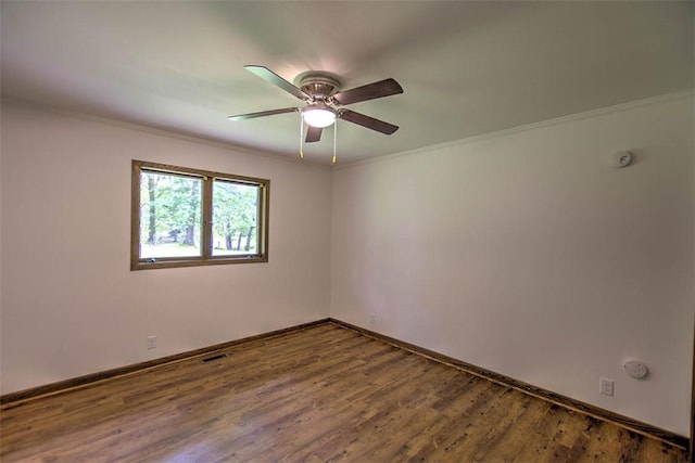 5959 Heritage Ln, Oakley, IL 62501 - empty room with baseboards, ceiling fan, wood finished floors, and crown molding