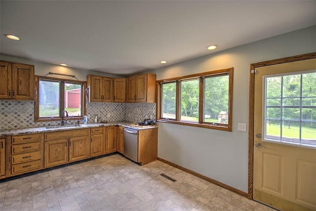 5959 Heritage Ln, Oakley, IL 62501 - kitchen with a sink, brown cabinetry, backsplash, baseboards, and recessed lighting