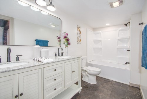 full bathroom featuring bathing tub / shower combination, vanity, and toilet