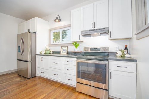 kitchen featuring white cabinets, light hardwood / wood-style floors, and appliances with stainless steel finishes