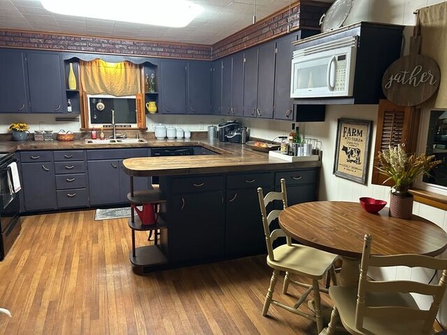 811 N Jefferson St, Robinson, IL 62454 - kitchen with open shelves, a sink, and blue cabinets