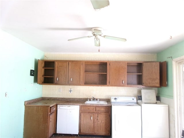 kitchen with white dishwasher, sink, washing machine and clothes dryer, and ceiling fan