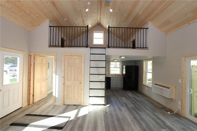 2805 Commercial Ave, Mattoon, IL 61938 - unfurnished living room with high vaulted ceiling, an AC wall unit, wood ceiling, plenty of natural light, and wood finished floors