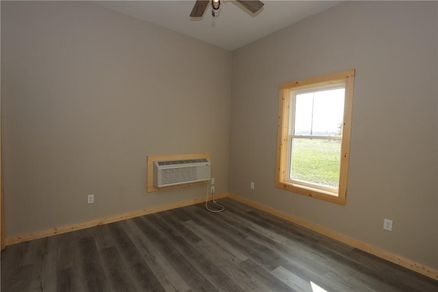 2805 Commercial Ave, Mattoon, IL 61938 - spare room with an AC wall unit, wood finished floors, and a ceiling fan