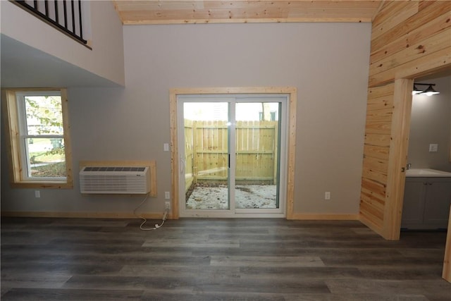 2805 Commercial Ave, Mattoon, IL 61938 - unfurnished living room featuring a wall unit AC, dark wood-style floors, and wood walls
