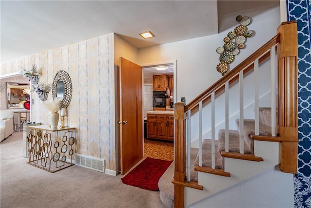 stairs featuring carpet floors