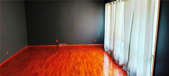 empty room featuring wood-type flooring