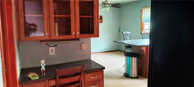 kitchen with dark stone countertops and ceiling fan