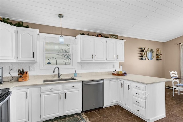 kitchen featuring a peninsula, a sink, white cabinets, light countertops, and appliances with stainless steel finishes