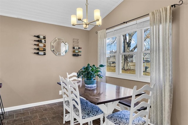 dining room with ornamental molding, a chandelier, and baseboards