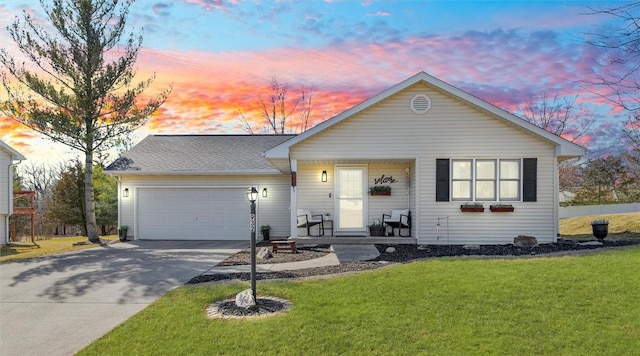 view of front of house featuring a garage, concrete driveway, and a front lawn