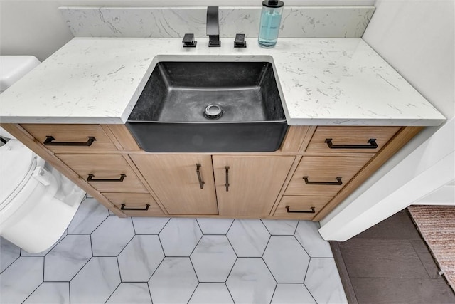 details featuring light stone counters and a sink