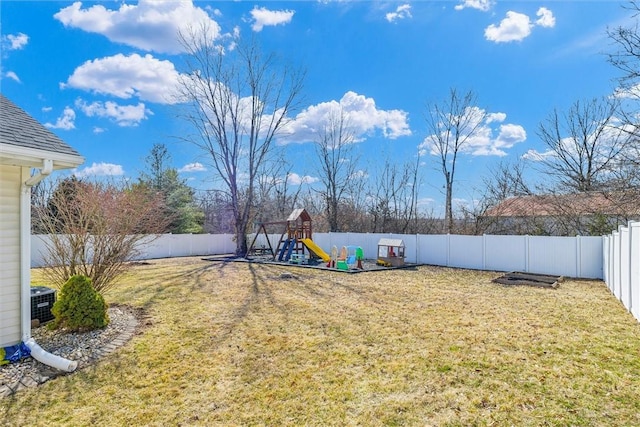 view of yard featuring a fenced backyard, central AC unit, and a playground