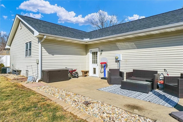 rear view of house featuring a shingled roof, cooling unit, outdoor lounge area, and a patio