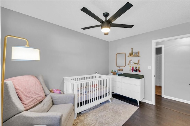 bedroom with a ceiling fan, baseboards, and wood finished floors