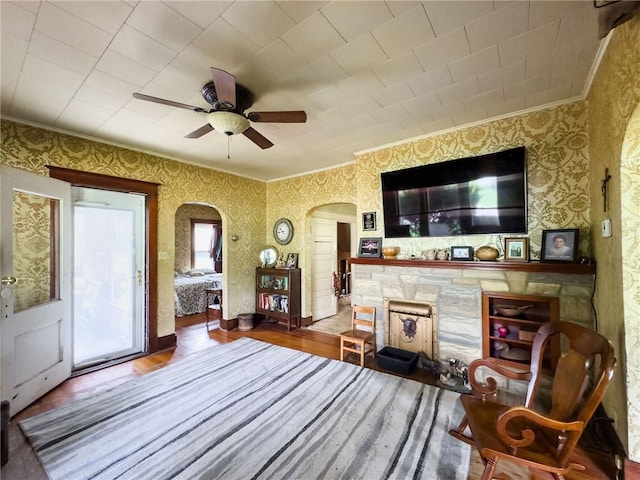 1625 Archer Ave, Marshall, IL 62441 - living area with ceiling fan, arched walkways, a fireplace, wood finished floors, and ornamental molding