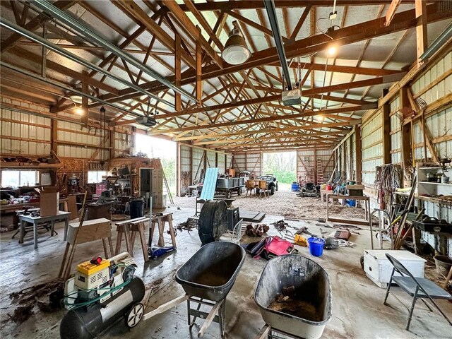 1625 Archer Ave, Marshall, IL 62441 - misc room featuring a workshop area, concrete floors, high vaulted ceiling, and a garage