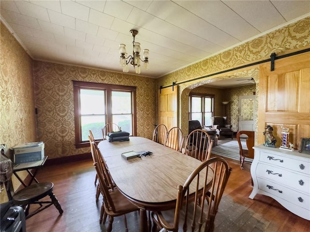 1625 Archer Ave, Marshall, IL 62441 - dining area featuring arched walkways, wallpapered walls, a barn door, and dark wood-type flooring