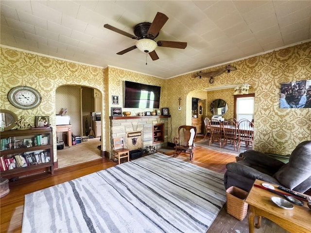 1625 Archer Ave, Marshall, IL 62441 - living room featuring crown molding, arched walkways, and wallpapered walls