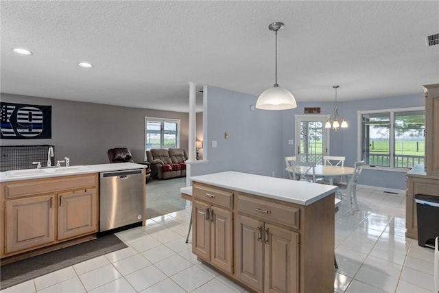 kitchen with stainless steel dishwasher, a kitchen island, recessed lighting, light countertops, and a sink