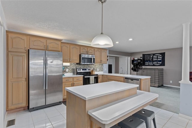 kitchen featuring appliances with stainless steel finishes, a sink, light tile patterned floors, light countertops, and recessed lighting