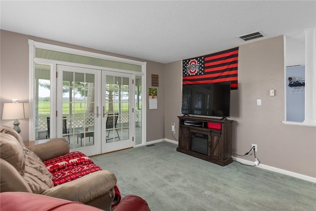 living area with carpet floors, baseboards, visible vents, and french doors