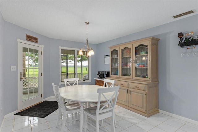 dining room with an inviting chandelier, baseboards, light tile patterned flooring, and visible vents