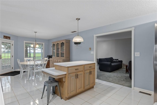 kitchen featuring visible vents, light countertops, light tile patterned floors, and light carpet