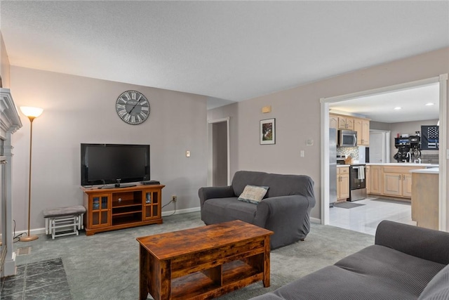 living room with baseboards and light colored carpet