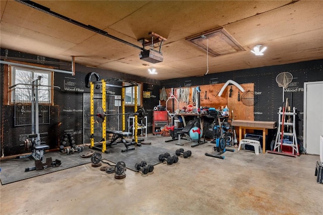 garage with a garage door opener and a workshop area