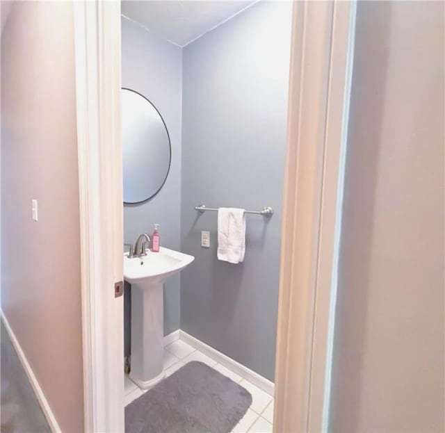 bathroom with baseboards, a sink, and tile patterned floors