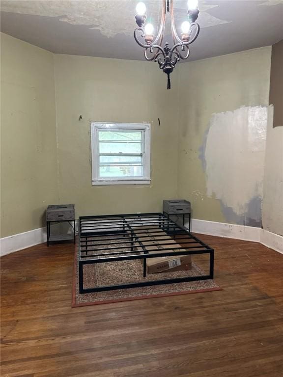202 S College St, Blue Mound, IL 62513 - interior space with baseboards, a chandelier, and wood finished floors