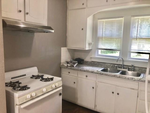 906 S 3rd St, Effingham, IL 62401 - kitchen with white gas range oven, under cabinet range hood, and white cabinets