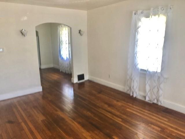 906 S 3rd St, Effingham, IL 62401 - spare room featuring arched walkways and hardwood / wood-style flooring