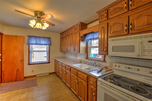 kitchen featuring ceiling fan, white appliances, plenty of natural light, and sink