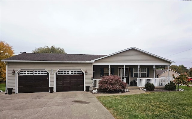 404 Deere Run Ln, Casey, IL 62420 - ranch-style home featuring a garage, driveway, covered porch, and a front yard