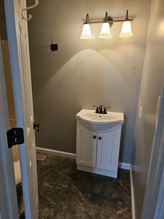 bathroom featuring baseboards and vanity