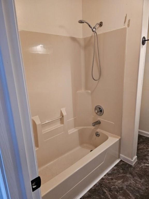 full bath featuring baseboards and shower / washtub combination