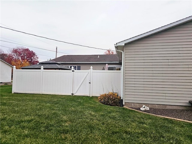 view of yard with fence and a gate