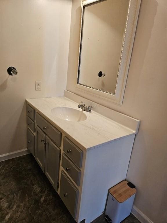 bathroom with baseboards and vanity