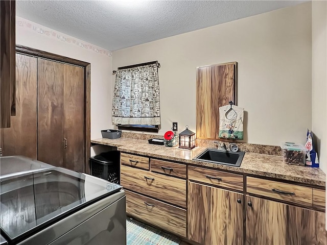 2321 Shelby Ave, Mattoon, IL 61938 - kitchen featuring range with electric stovetop, a textured ceiling, light countertops, and brown cabinets