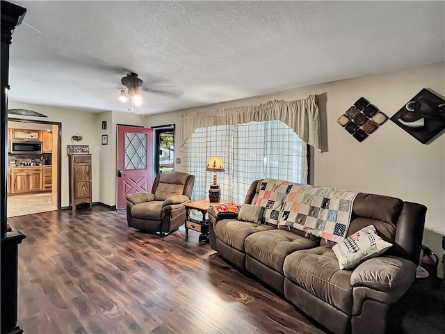 2321 Shelby Ave, Mattoon, IL 61938 - living area with dark wood-style flooring, ceiling fan, and a textured ceiling