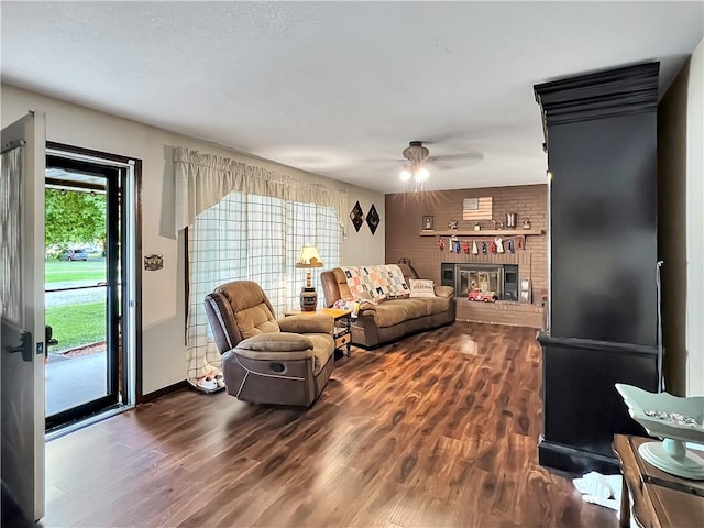 2321 Shelby Ave, Mattoon, IL 61938 - living room featuring dark wood-style floors, a ceiling fan, and a fireplace