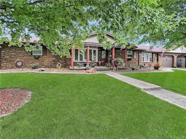 2321 Shelby Ave, Mattoon, IL 61938 - view of front facade featuring a front yard, a garage, brick siding, and driveway