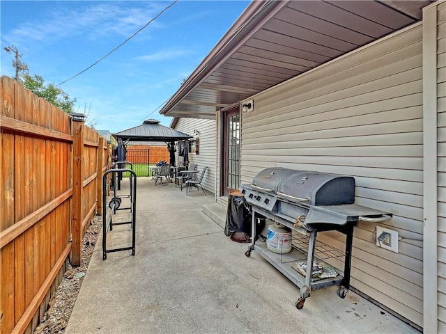 2321 Shelby Ave, Mattoon, IL 61938 - fenced backyard featuring a gazebo, a patio, a grill, and outdoor dining space