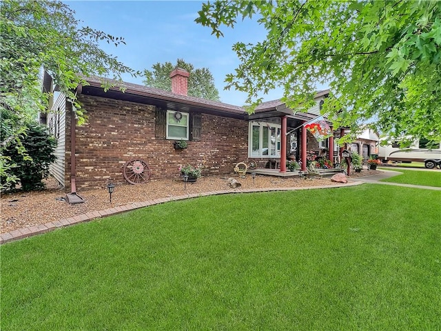 2321 Shelby Ave, Mattoon, IL 61938 - single story home with a front lawn, a chimney, and brick siding